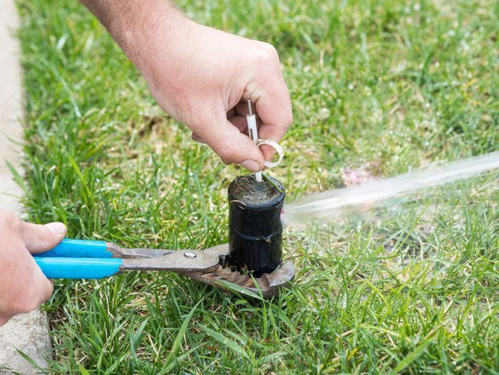 Turning on a sprinkler system with a key and pliers